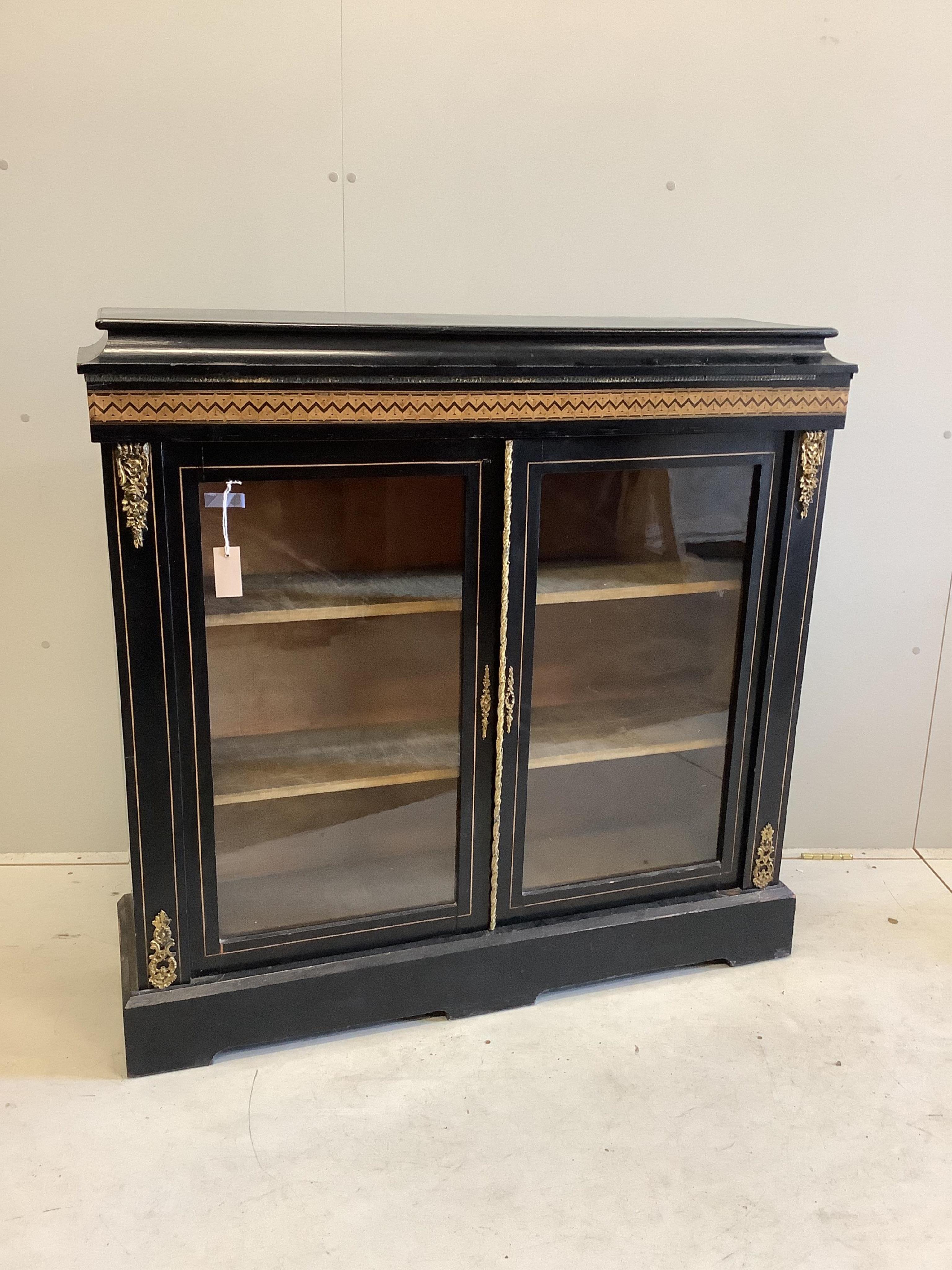 A late Victorian parquetry inlaid gilt metal mounted ebonised pier cabinet, width 113cm, depth 34cm, height 110cm. Condition - fair